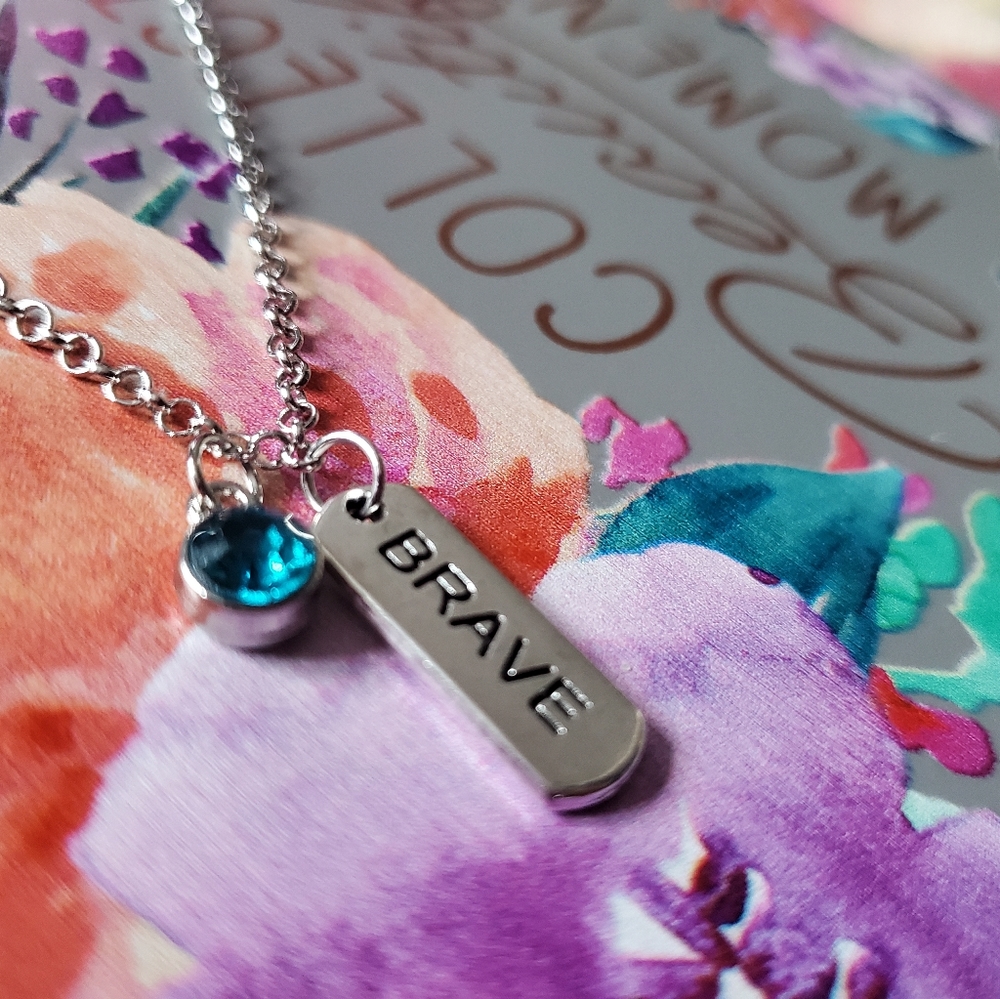 Brave charm necklace with light blue gem